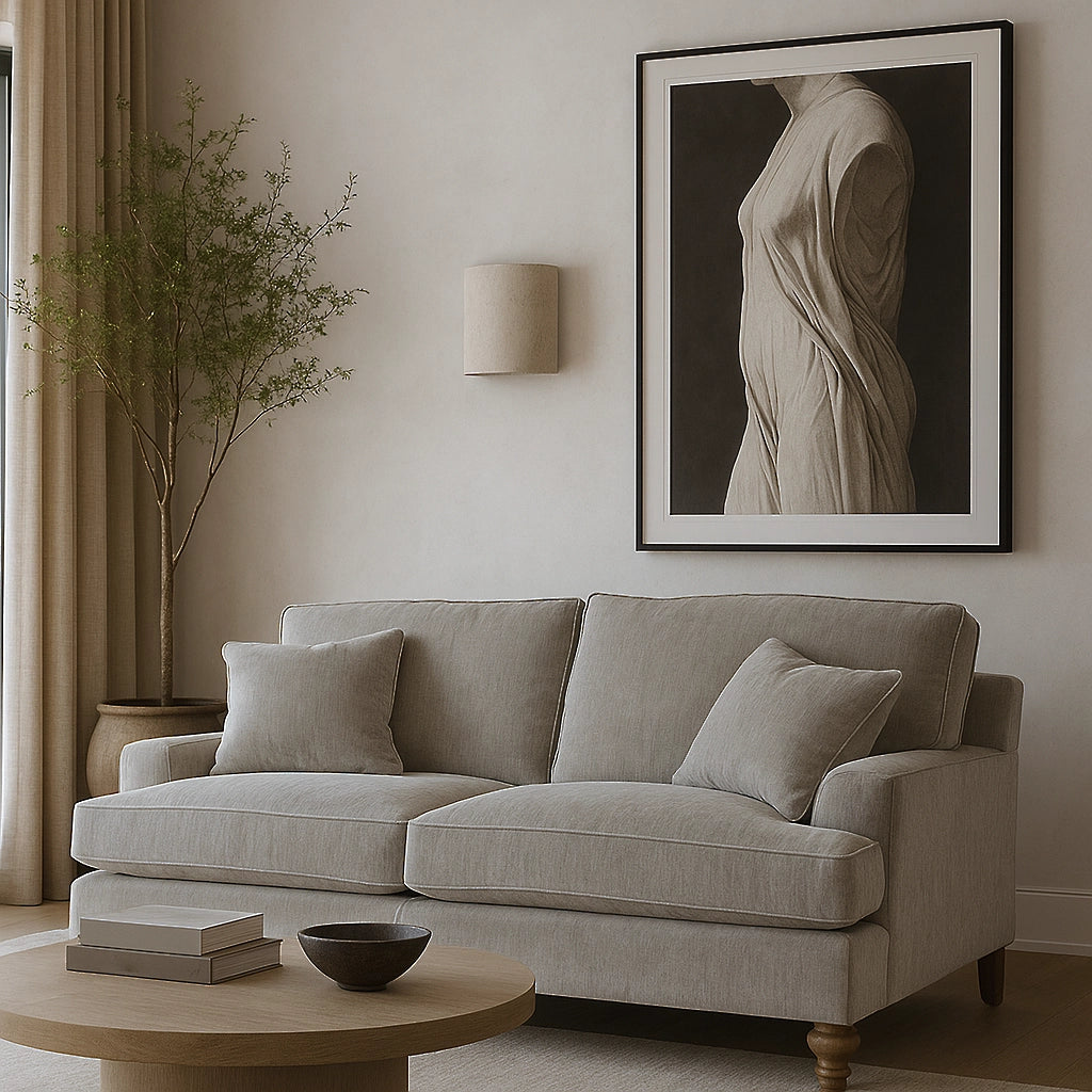 Gray sofa in a living room with a framed artwork on the wall.