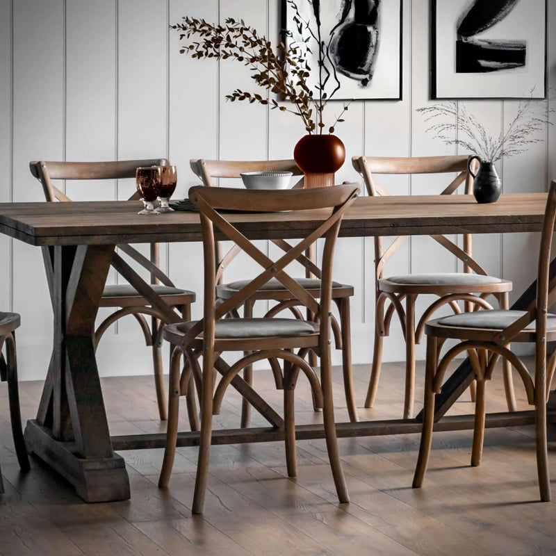 Cross-back dining chairs around an oak dining table - Escapology Home