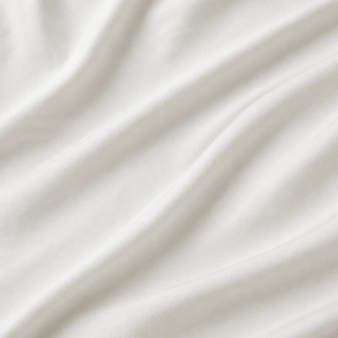 Close-up of soft white Egyptian cotton sateen fabric with gentle folds