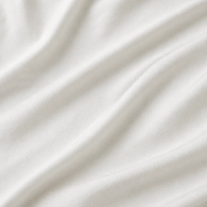 Close-up of soft white Egyptian cotton sateen fabric with gentle folds