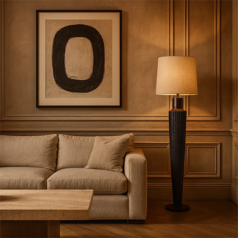 Living room with beige sofa, wooden coffee table, and floor lamp against a wall with a large abstract painting.
