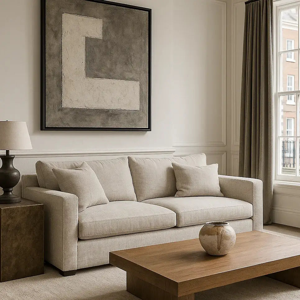 Beige sofa and furniiture in a living room with abstract art and wooden coffee table - Escapology Home