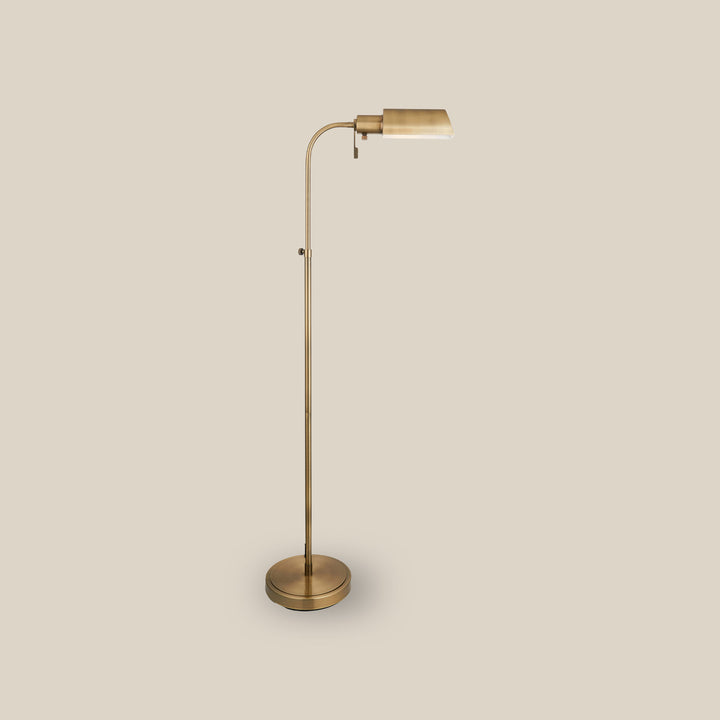 Elegant brass floor lamp with adjustable arm and modern design, perfect for reading or ambient lighting in stylish interiors.